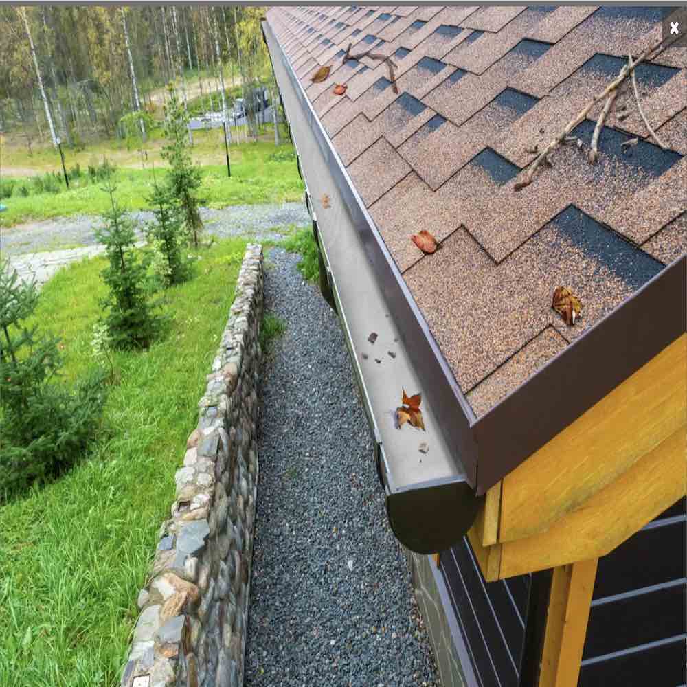 Aluminium gutter guard mesh fitted along a house gutter